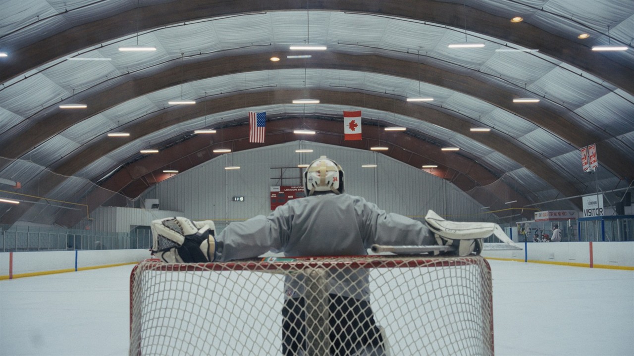 Back of a hockey goalie standing in net
